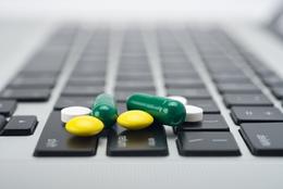 Online prescription order concept with bottles of medicine on keyboard